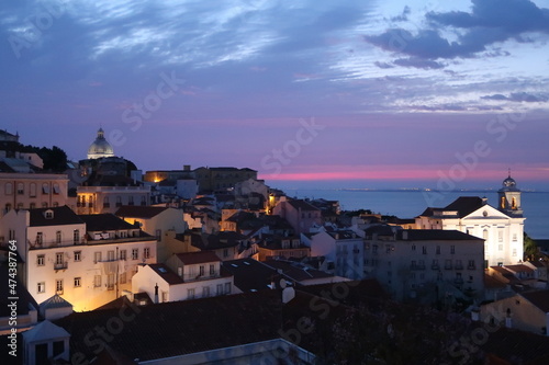 Cityscape Image of Lisbon, Portugal during dramatic sunrise.