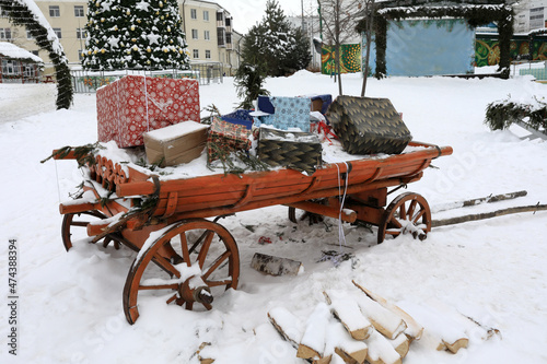 Wooden cart with christmas gift boxes © Arkady Chubykin