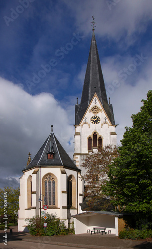 Medieval church in the village of Daxweiler with bell tower and gothic apse, Hunsrück region in Germany