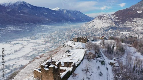 Aerial 4K, Castel Grumello and vineyards, near Sondrio in Valtellina, winter view	