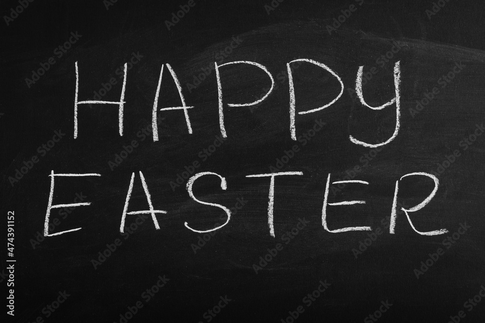 Happy Easter written on a blackboard. Easter on chalk board. Happy Easter written on a blackboard. Easter on chalk board.
