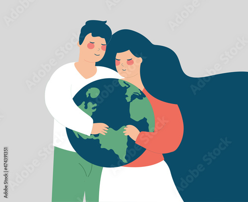 Happy couple embrace the globe with care. Man and woman hold the green planet with love. Earth day, saving the environment and energy, planet conservation, climat change and global warming concept.