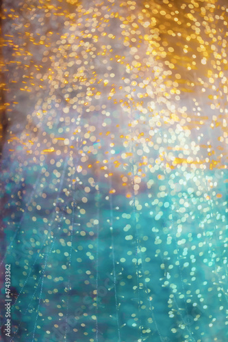 Beautiful lights on a blurred blue and gold background, blur at shallow depth of field