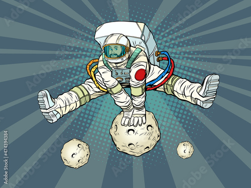 The astronaut rejoices jumping up through an asteroid or planet in a funny pose with his legs apart. Space and science