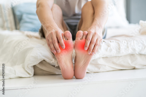 Foot pain, man suffering from feet ache at home © staras