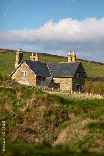 House nestled in between the fields and rolling hills © Charles