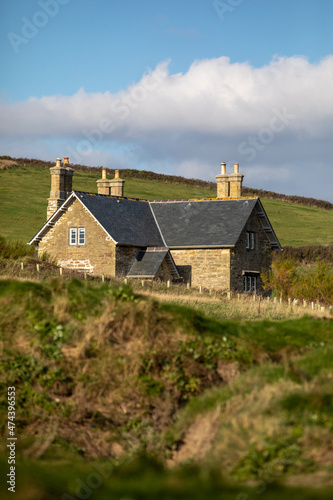 House nestled in between the fields and rolling hills