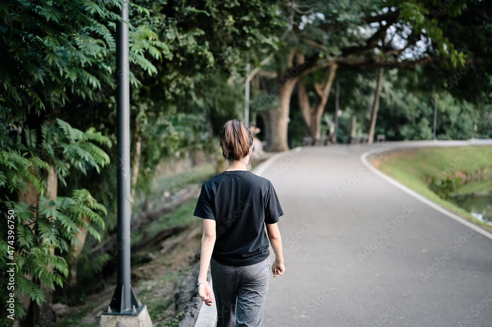 Rear view point of young woman walking on the way , hope and dream concept