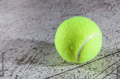 Close up of tennis ball on asphalt tennis court © azyryanov