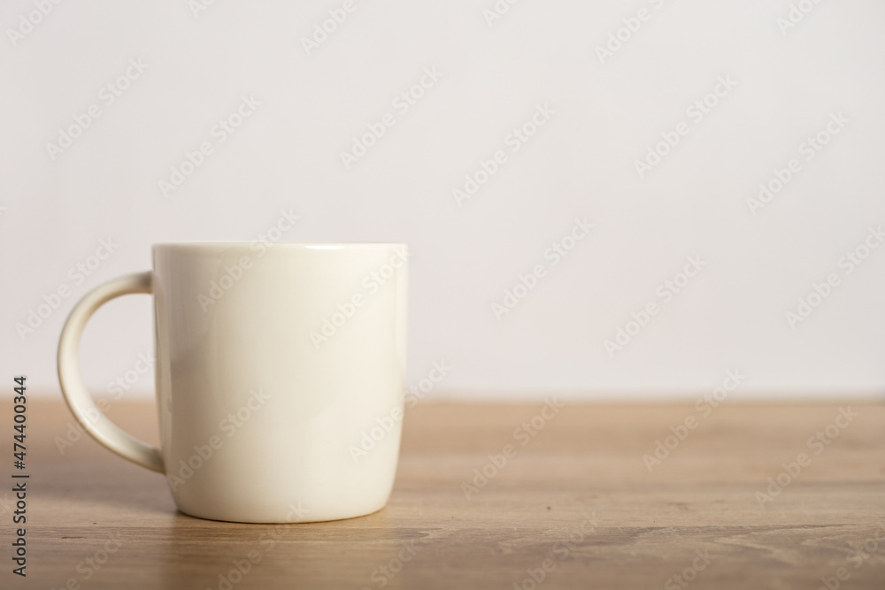 A mug with a hot drink on the table. Breakfast or coffee at night A mug with a hot drink on the table. Breakfast or coffee at night