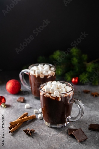 Glass mug with hot chocolate cocoa drink with marshmallow. Copy space. Dark background. Low key. Winter, Christmas and New Year food and drink concept.