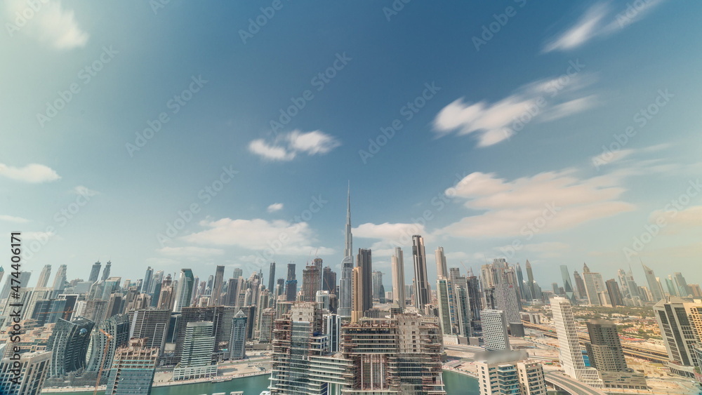 Cloudy blue sky over panoramic skyline of Dubai with business bay and downtown district timelapse.