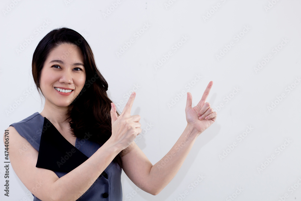 Asian woman with smiling are indicate and pointing to blank space for promotion and advertisement and present an information. Asian woman with smiling are indicate and pointing to blank space for promotion and advertisement and present an information.