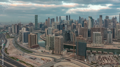 Skyline with modern architecture of Dubai business bay towers morning timelapse. Aerial view