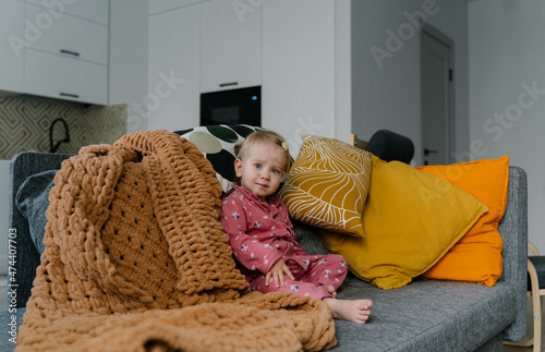 little girl sitting on the couch