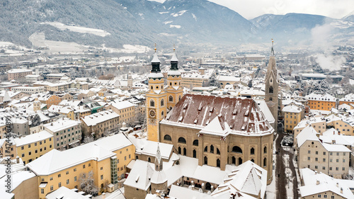 Cathedral of Santa Maria Assunta and San Cassiano in Bressanone. Brixen, is a little town in South Tirol in northern Italy. Aerial view of the old center city covered with snow in winter time. photo