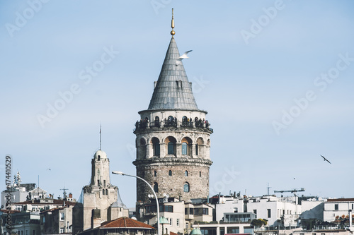 Galata Tower in Istanbul during the daytime. Buildings around the historical tower.