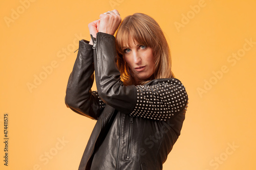 Billede på lærred Portrait of an attractive blonde woman wearing a studded leather jacket against