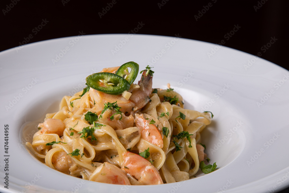 Italian pasta with prawns chili pepper and greens. Italian food