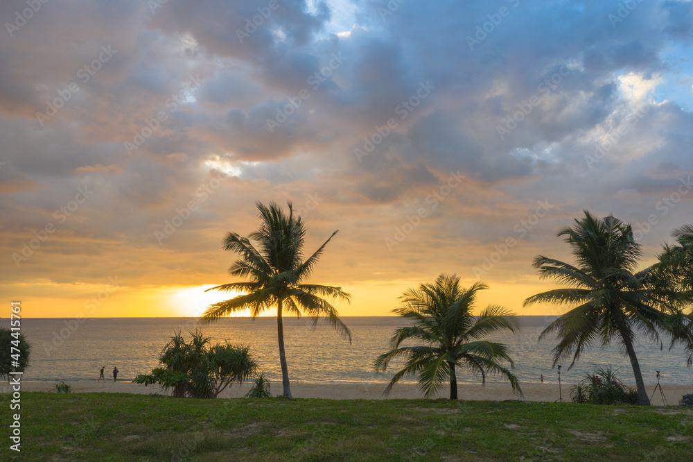 Scene of Colorful romantic sky sunset with coconuts in sunset background.cloud in sunset on Karon beach Phuket Thailand. .Scene of Colorful yellow light in the sky background.