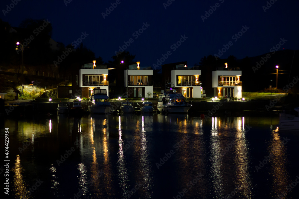 Residential area in Norway with houses facing the sea at night