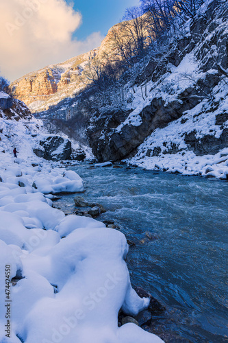 Mountain river flowing in the gorge in winter