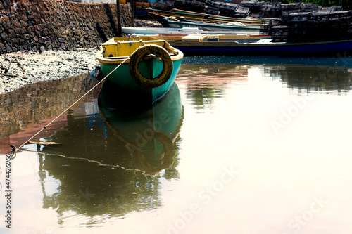 Canoes and colorful boats docked on the Paraguacu River photo