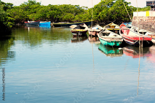 Canoes and colorful boats docked on the Paraguacu River photo