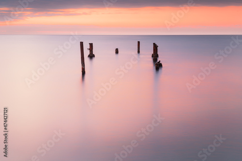 Pink sunrise at the sea coast. Long exposure shot. Minimalistic seascape. Abstract nature background