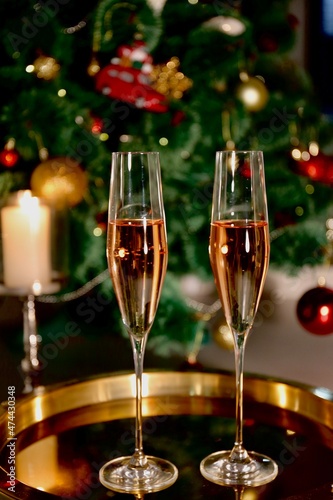 Selective focus glasses of champagne near the new year tree in the new year 2022