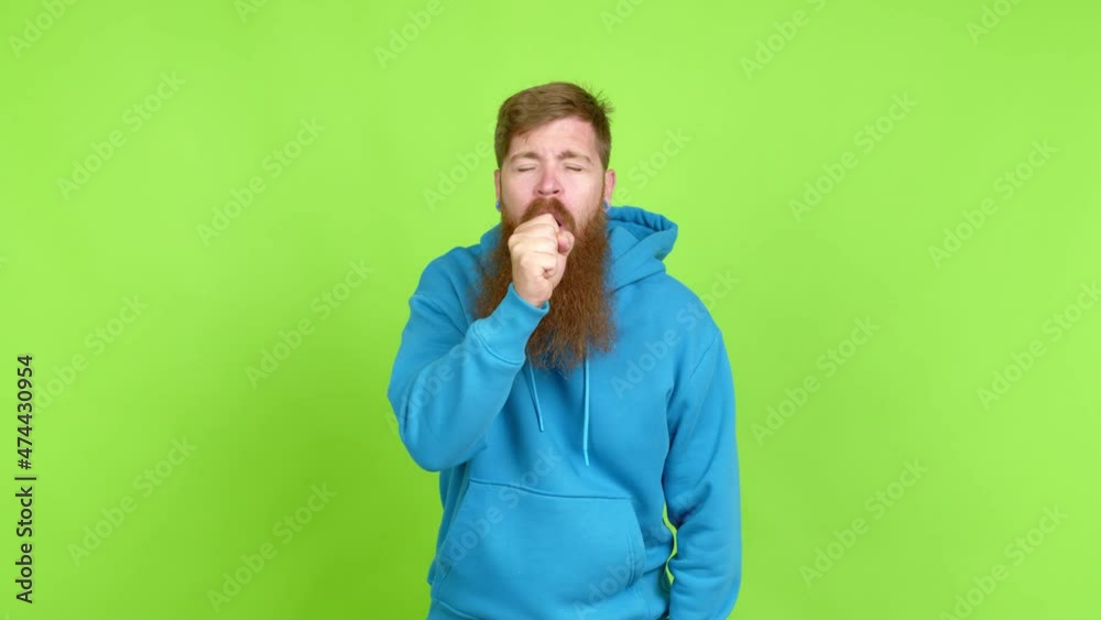 Redhead man with long beard is suffering with cough and feeling bad over isolated background Redhead man with long beard is suffering with cough and feeling bad over isolated background
