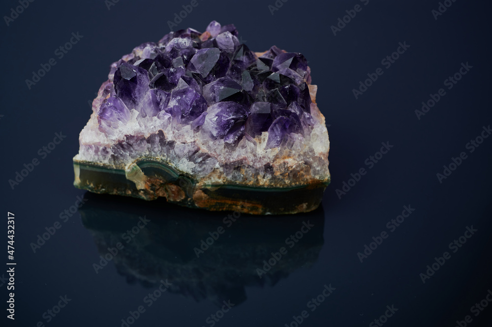 macro color photo of amethyst gemstone against dark background