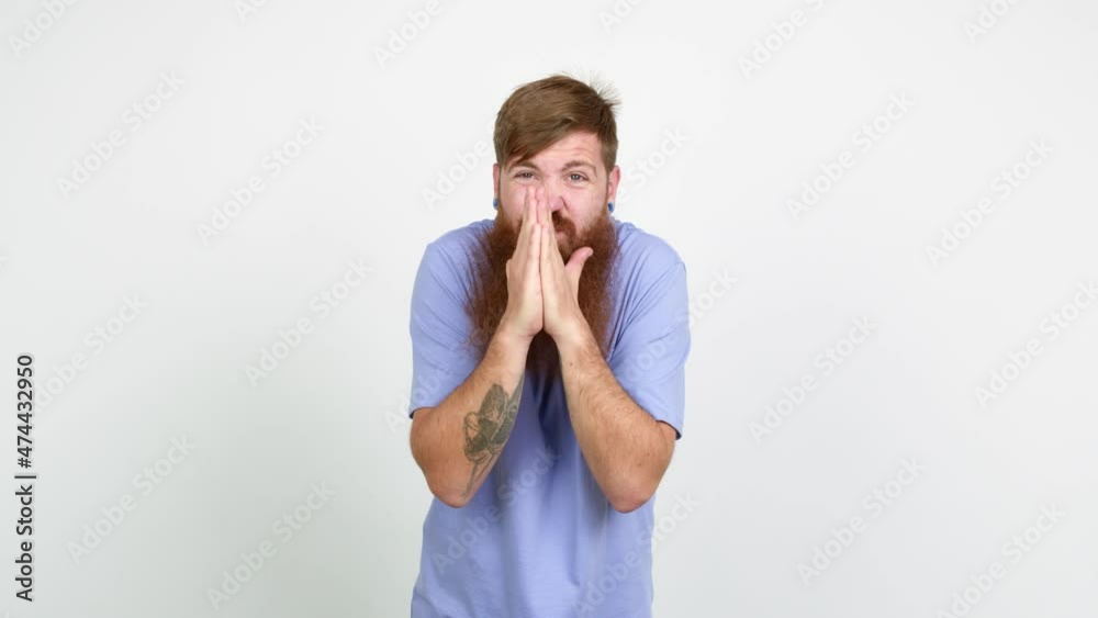 Redhead man with long beard pleading over isolated background Redhead man with long beard pleading over isolated background