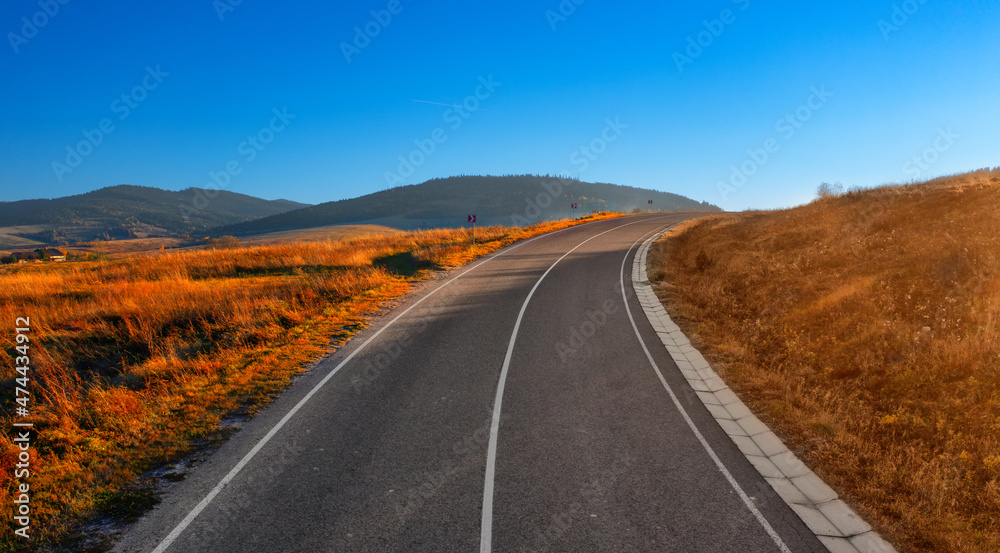 Paved road in the mountains. Autumn landscape at sunset. Paved road in the mountains. Autumn landscape at sunset.