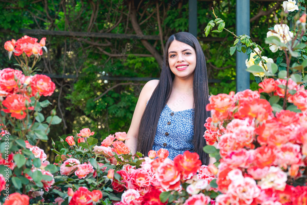 Young woman portrait with spring flowers at park