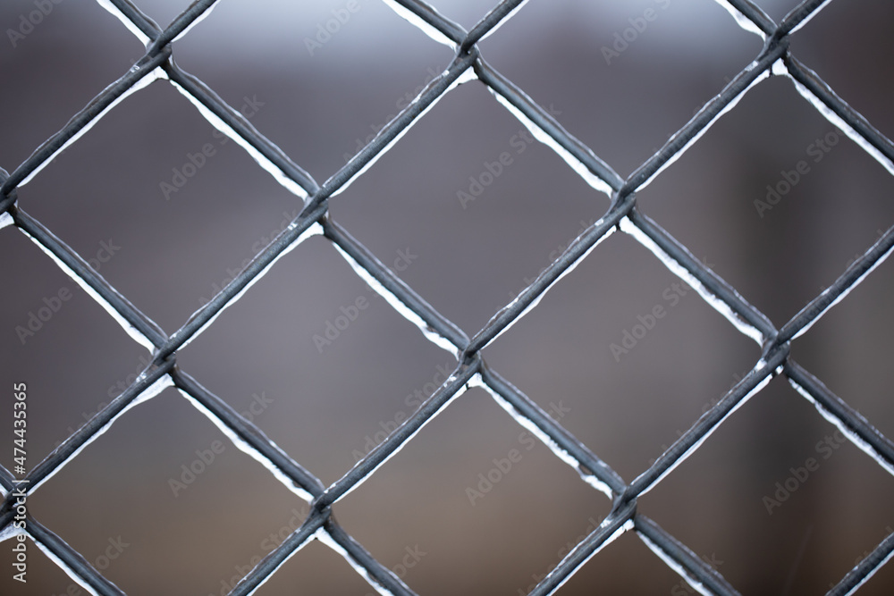 Metal old rusty mesh covered with ice.