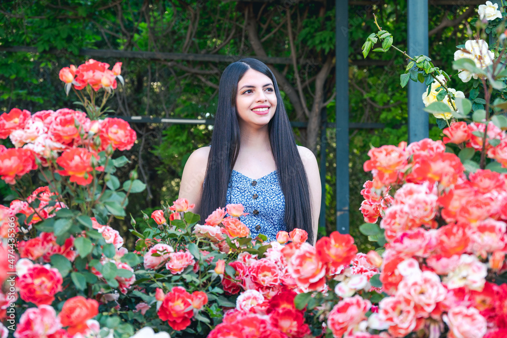 Young woman portrait with spring flowers at park