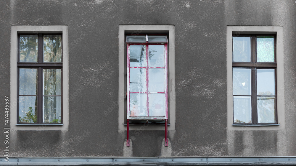 Fototapeta premium The red box window on the gray facade 