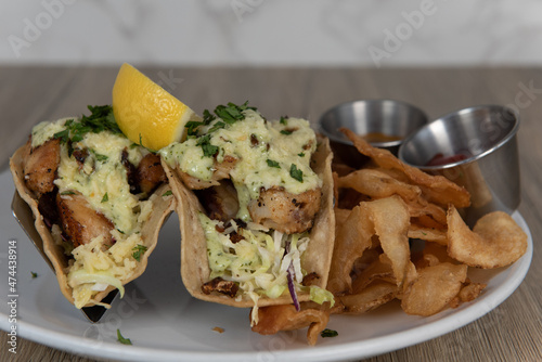 Billede på lærred Artistic presentation of grilled tacos smothered in melted cheese and served wit
