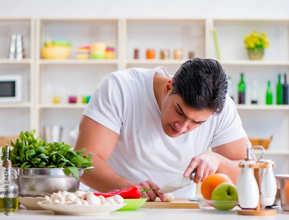 Young male cook working in the kitchen Young male cook working in the kitchen