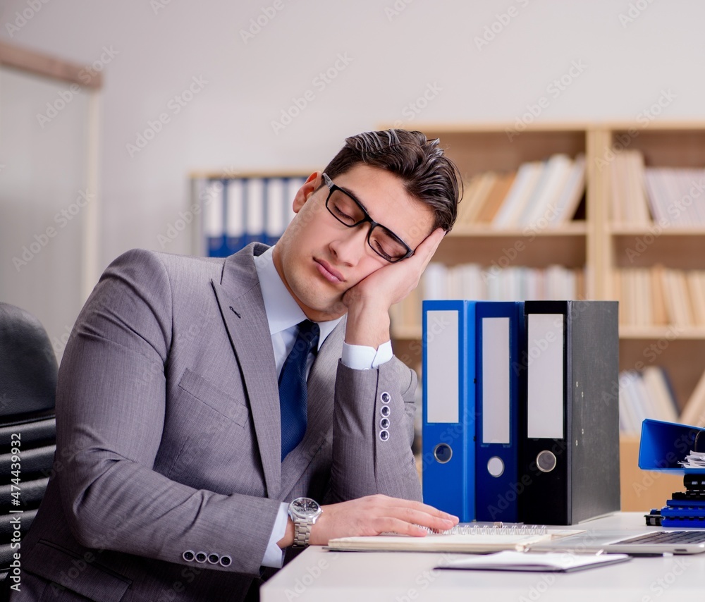Sleepy businessman working in office Sleepy businessman working in office