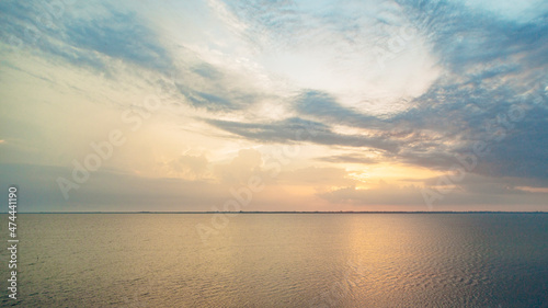 Beautiful Landscape of the Sunset on the Beach. Calm Weather with Blue Clouds in the Blue Sky Reflected in the Water