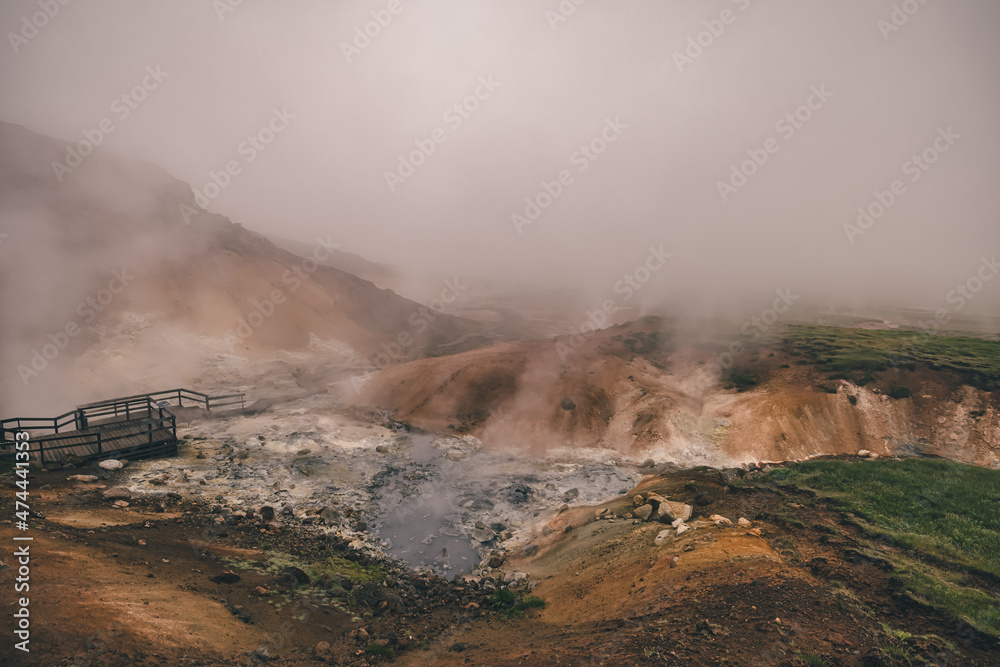 Empty geothermal Krysuvik area on Reykjanes peninsula in Iceland on early summer morning. Visible sulphur rising from the ground.