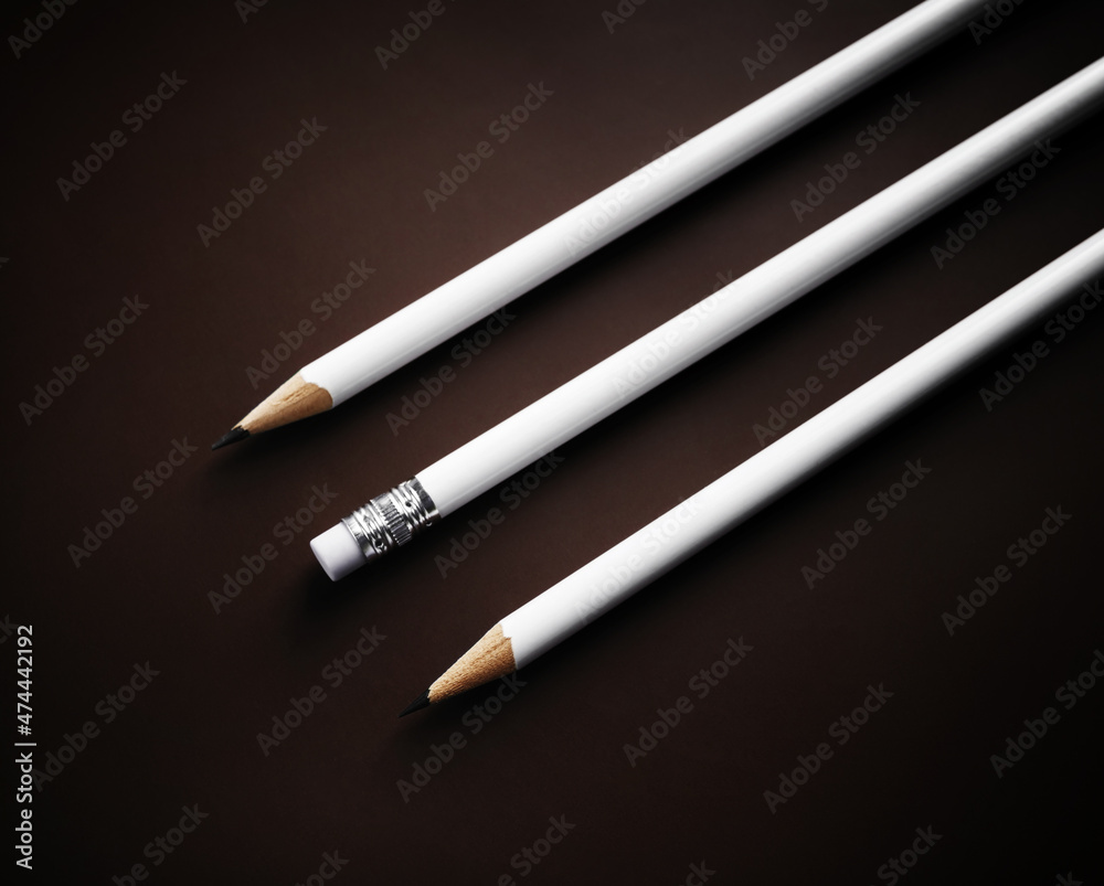 Photo of three simple blank pencils on dark background. Photo of three simple blank pencils on dark background.