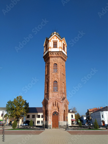 Brick restored water tower in the Art Nouveau architectural style rises on the central square of the ancient city of Staraya Russa, Novgorod region. Industrial architecture of the early XX century 