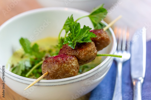 Grilled meatballs with vegetables and herbs on a skewer
