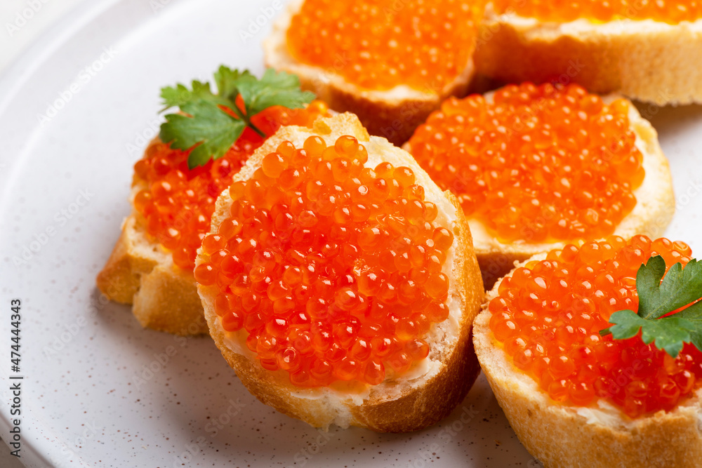 Delicious Sandwiches with red caviar on a white plate background Delicious Sandwiches with red caviar on a white plate background