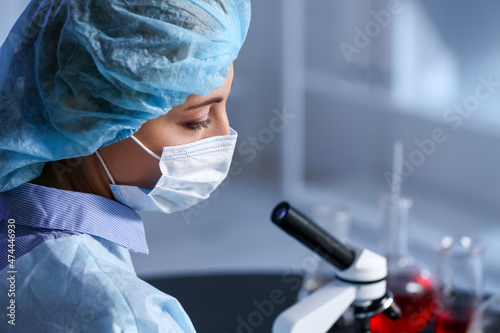 Scientist studying sample in laboratory