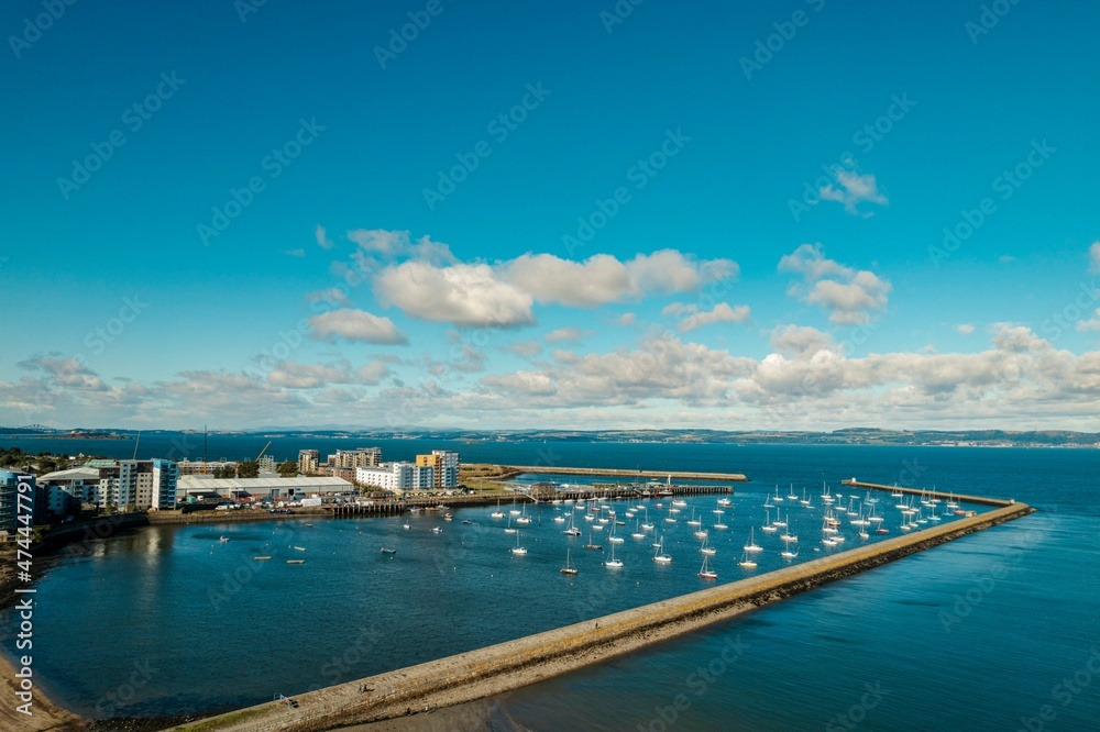 Iconic marina, located along the east coast of Scotland, presents a stunning view of the sea. Taking an aerial view of the marina, the image displays a stunning image of the marina yachts and boats.