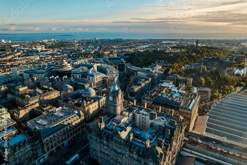 Aerial view of Edinburgh as the sun rises over the city. Early morning mist creeps along the shoreline of the North Sea like steam rising from a mug of freshly brewed coffee © Damian